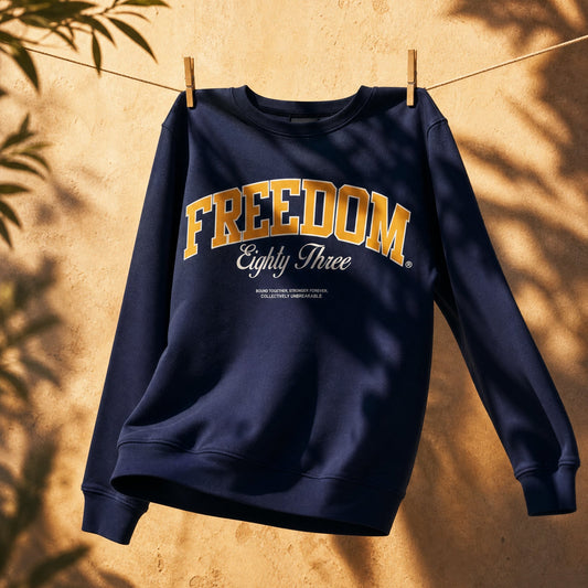 Navy blue sweatshirt with 'Freedom Eighty Three' text on a beige background